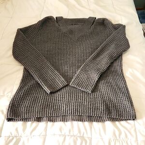 Gray v neck sweater with cut out at the v.  Tags cut out,  but about a size lg